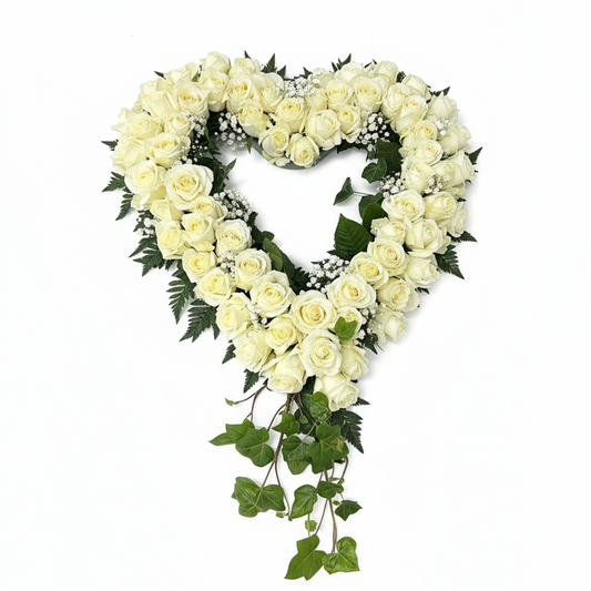 Cremefärgad begravningskrans med små rosor